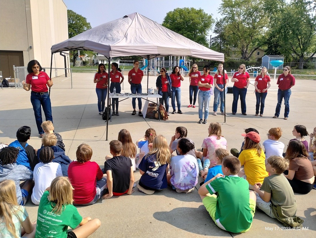 Arti Singh, associate professor, agronomy (far left), speaking to students at Fellows Elementary School in Ames, with representatives of the new Iowa State University group, Women in Agriculture and Artificial Intelligence (WIAA). Image below: Iowa State graduate student Ashlyn Rairdin (center) with other members of WIAA demonstrating a drone to an elementary school group. Pictures by Venkata Naresh Boddepalli.