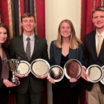 The ISU Crops Team from left: Elizabeth Tranel, Tyler Atkinson, Courtney Harle, and Aidan Bobholz with some of their awards.